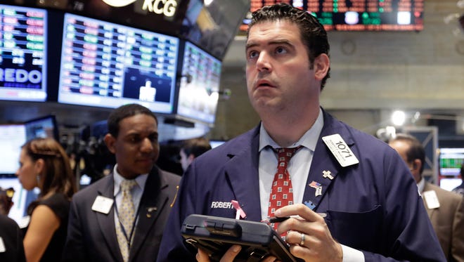 Trader Robert McQuade works on the floor of the New York Stock Exchange on Sept. 25, 2013.