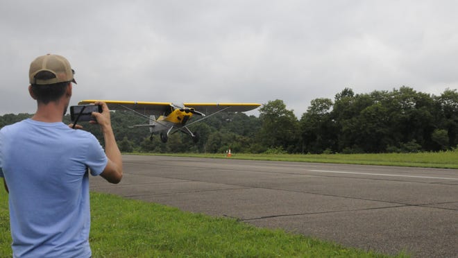 Ed Smith, recreational manager at Noble County Airport, takes a video of the takeoff of Harmon Lantz, of St. Clairsville, during Saturday morning's STOL (Short Take-off and Landing) contest at the airport.