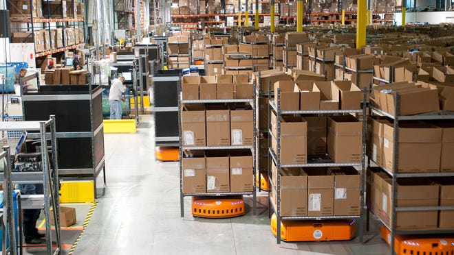 Kiva Systems produces the short, squat, orange robots pictured here that move goods around warehouses efficiently.