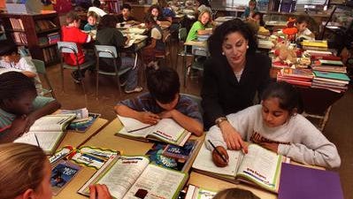 A fifth-grade teacher works with her students.