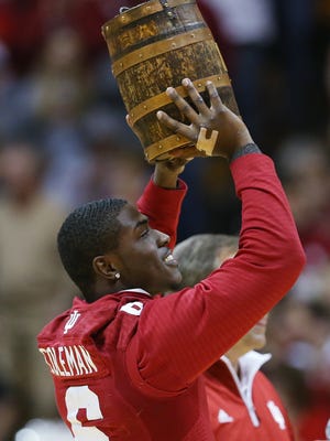 Indiana Hoosiers running back Tevin Coleman shows the Indiana basketball crowd the Old Oaken Bucket during a break in the game Monday night. The Hoosiers take on Purdue in the annual rivalry this Saturday. Indiana hosted Eastern Washington at Assembly Hall on Monday, November 24, 2014.
