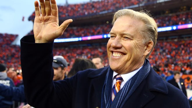 Denver Broncos general manager John Elway celebrates after defeating the New England Patriots in the AFC Championship game at Sports Authority Field at Mile High.