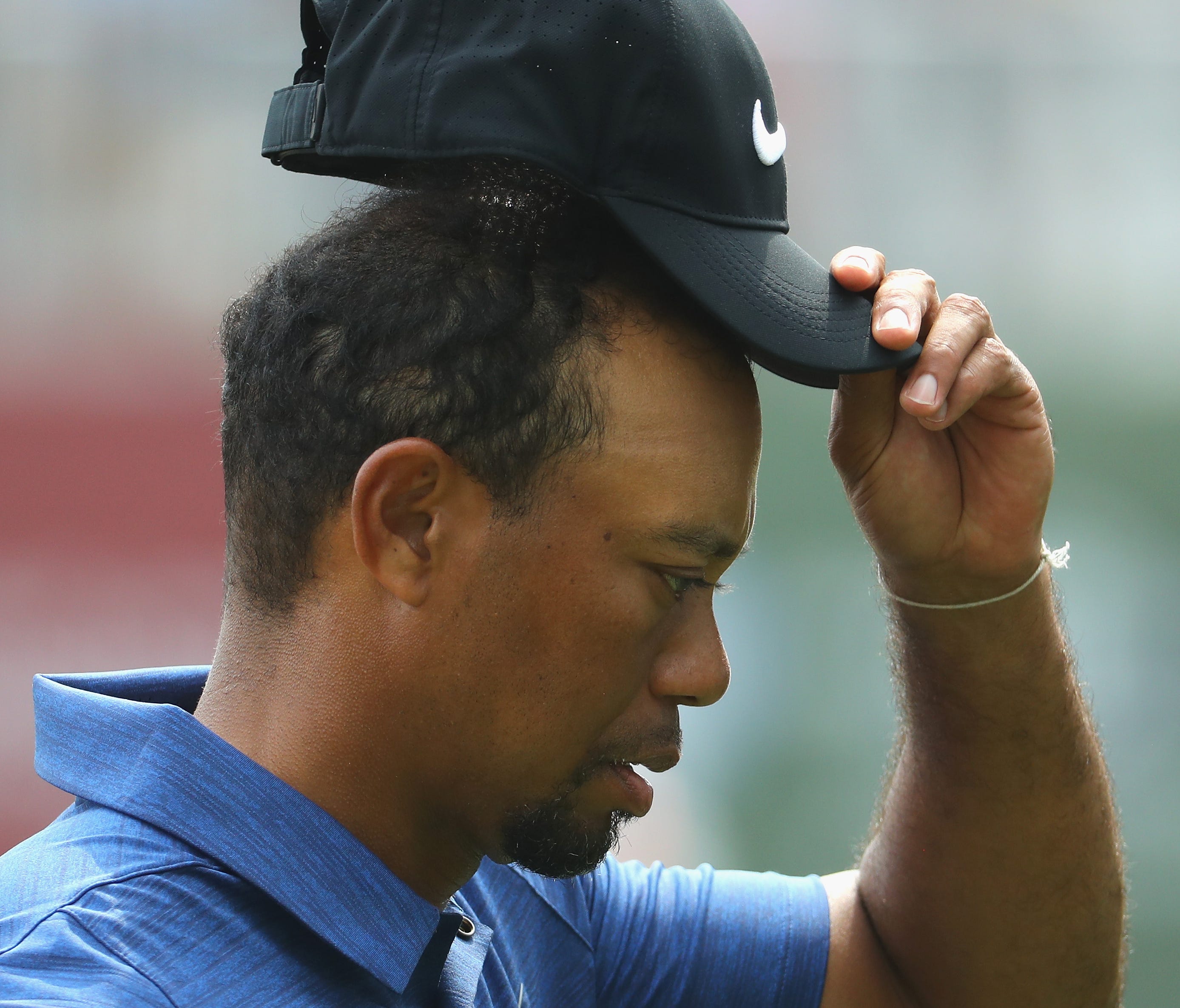 Tiger Woods acknowledges the crowd on his last hole during the first round of the Omega Dubai Desert Classic at Emirates Golf Club.