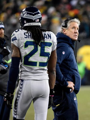 Seattle Seahawks head coach Pete Carroll reacts with cornerback Richard Sherman (25) in the third quarter during the game against the Green Bay Packers at Lambeau Field.