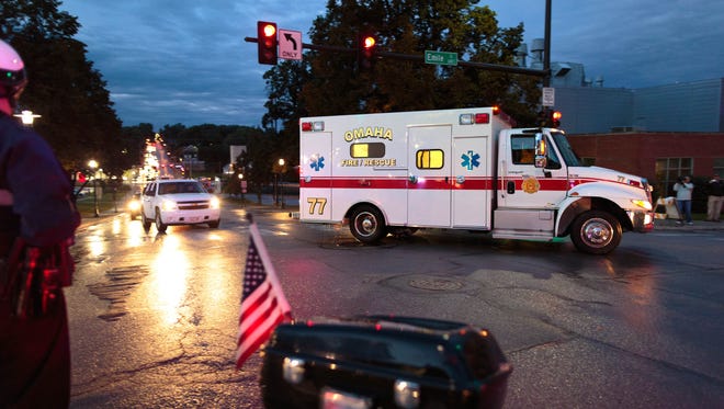 The ambulance transporting Dr. Rick Sacra, 51, who was infected with Ebola while serving as an obstetrician in Liberia, arrives with a police escort on Friday at the Nebraska Medical Center in Omaha. Sacra, who served with North Carolina-based charity SIM, is the third American aid worker infected by the Ebola virus.