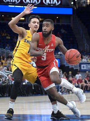 Houston guard Corey Davis Jr. (5) drives to the basket in front of Wichita State guard Landry Shamet (11) during the first half of an NCAA college basketball game in the semifinals at the American Athletic Conference tournament Saturday, March 10, 2018, in Orlando, Fla. (AP Photo/Phelan M. Ebenhack)