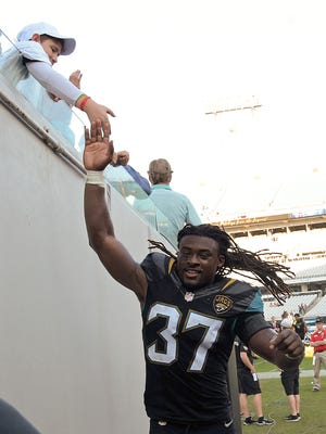 Jacksonville Jaguars strong safety Johnathan Cyprien high-fives a fan after defeating the Tennessee Titans on Dec. 24, 2016, in Jacksonville, Fla.