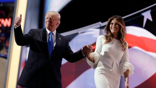 Republican presidential candidate Donald Trump gives his thumb up as he walks off the stage with his wife Melania during the Republican National Convention, Monday, July 18, 2016, in Cleveland.