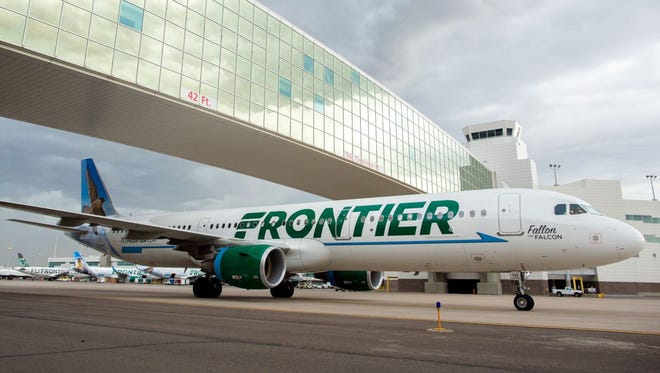 A Frontier Airbus A321 passes under the landmark pedestrian bridge at Denver International Airport on May 7, 2017.