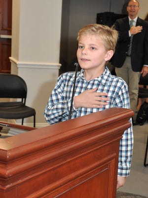 Nine-year-old Nicky Snow leads the Village of Estero Council in the Pledge of Allegiance Wednesday morning.