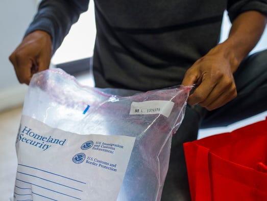 A man checks a bag with his belongings after released