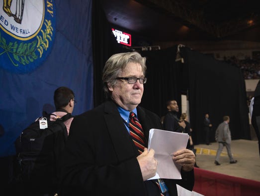 Bannon listens as Trump speaks at a rally in Louisville,