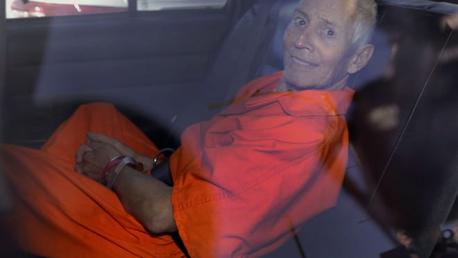 FILE - In this Tuesday, March 17, 2015, file photo, Robert Durst is transported from Orleans Parish Criminal District Court to the Orleans Parish Prison after his arraignment in New Orleans. The whispered words of Durst recorded in an unguarded moment in a bathroom could come back to haunt him - or help him - as he faces a murder charge. A possible move by prosecutors to introduce the incriminating material from a six-part documentary on his strange life and connection to three killings could back fire as interview footage did in the Michael Jackson molestation trial and the Robert Blake murder case. (AP Photo/Gerald Herbert, File)