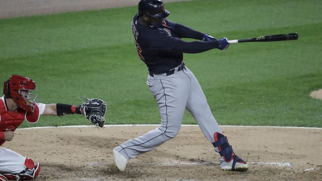 Cleveland Indians' Franmil Reyes hits an RBI double against the Chicago White Sox during the eighth inning of a baseball game in Chicago, Sunday, Aug. 9, 2020.