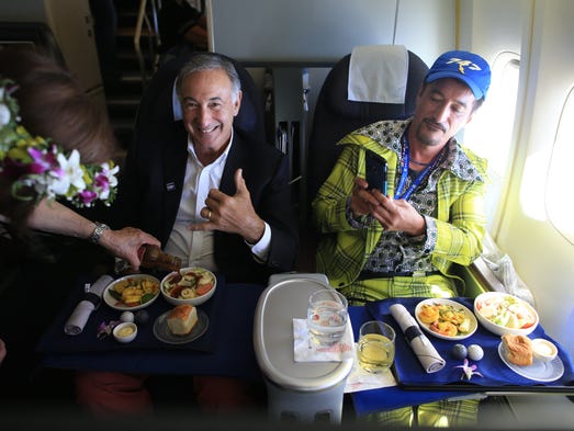 Crew members serve meals to passengers aboard the last