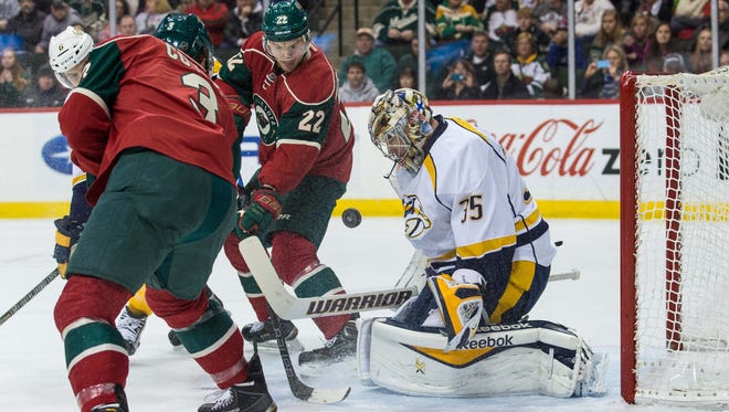 Predators goalie Pekka Rinne (35) makes a save on Wild forwards Nino Niederreiter (22) and Charlie Coyle (3) in the first period of Nashville’s 3-1 victory Saturday. Rinne has been in goal for all of the team’s wins this season.