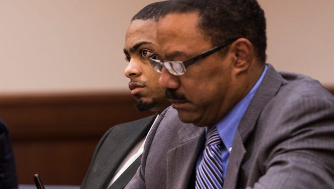 Curtis Shelton Jr. looks on after hearing his 17 guilty counts during verdict, while his defense attorney, Karl Pulley, takes notes on February 27, 2018.