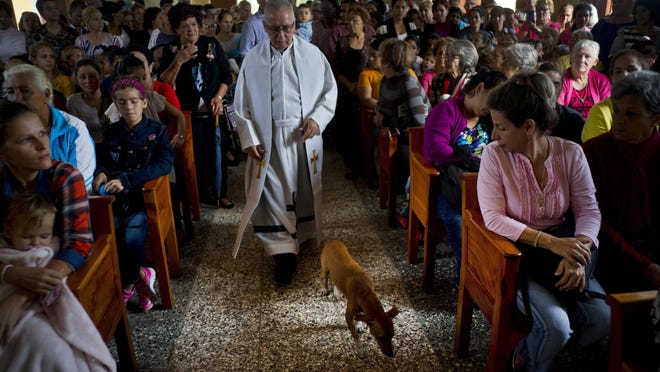 Father Cirilo Castro takes part in the consecration Mass of the Sagrado Corazon de Jesus, or Sacred Heart, Catholic church, in Sandino, Cuba, Saturday, Jan. 26, 2019. The parish is one of three Catholic churches that the Cuban government authorized to be built and the first of the three to be completely finished, with the help of Tampa's St. Lawrence Catholic Church in Florida.