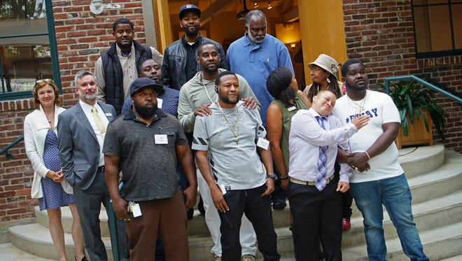 Six participants pose with staff from the Delaware Center for Horticulture and family after graduating from the Branches to Chances, A Return to Work Program, providing horticultural and life skills training to program trainees.