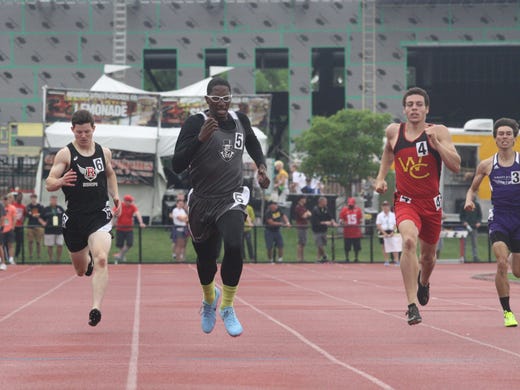 Oyler's Ricky Thomas II, middle, chases down the finish