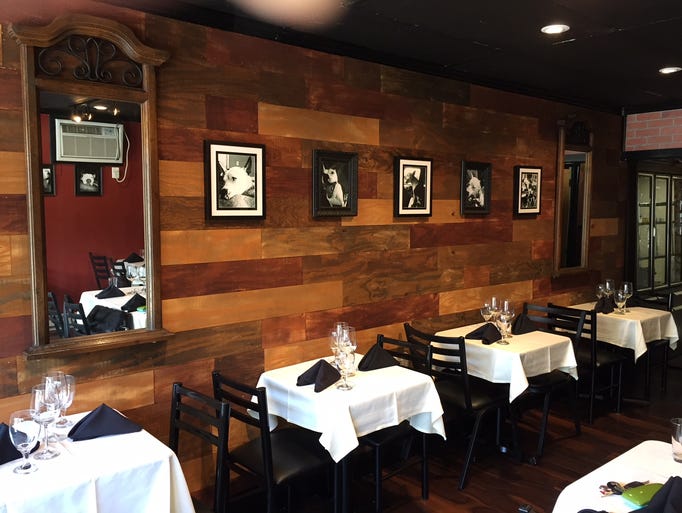 Black-and-white dog portraits line the walls of Silver
