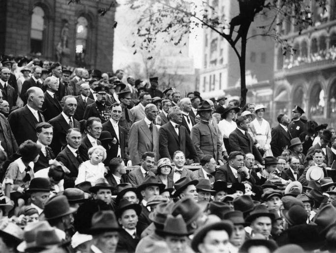 Crowds stand and watch a conscription parade in Detroit