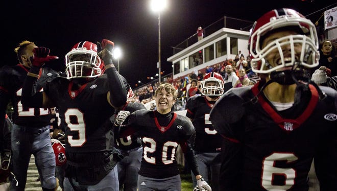 Port Huron players react as they score a touchdown during the Crosstown Showdown Friday, October 23, 2015 at Memorial Stadium in Port Huron.