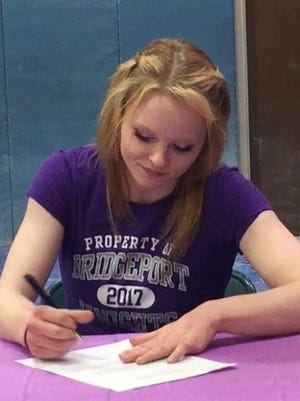 Regan Dillon signs a letter of intent to compete in gymnastics at the University of Bridgeport during a short ceremony at the Woodson YMCA on Thursday.