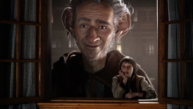 Ruby Barnhill portraying Sophie, right, appears in a scene with the Big Friendly Giant, voiced by Mark Rylance in "The BFG," opening nationwide on July 1.