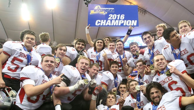 Somers players celebrate their 25-17 victory over Greece Athena to win the New York State Class A championship game at the Carrier Dome in Syracuse, N.Y. on Nov. 25, 2016.