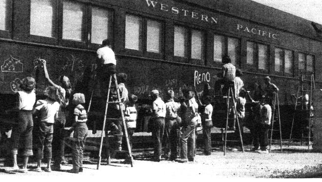 Passengers painting the circus train in Winnemucca.