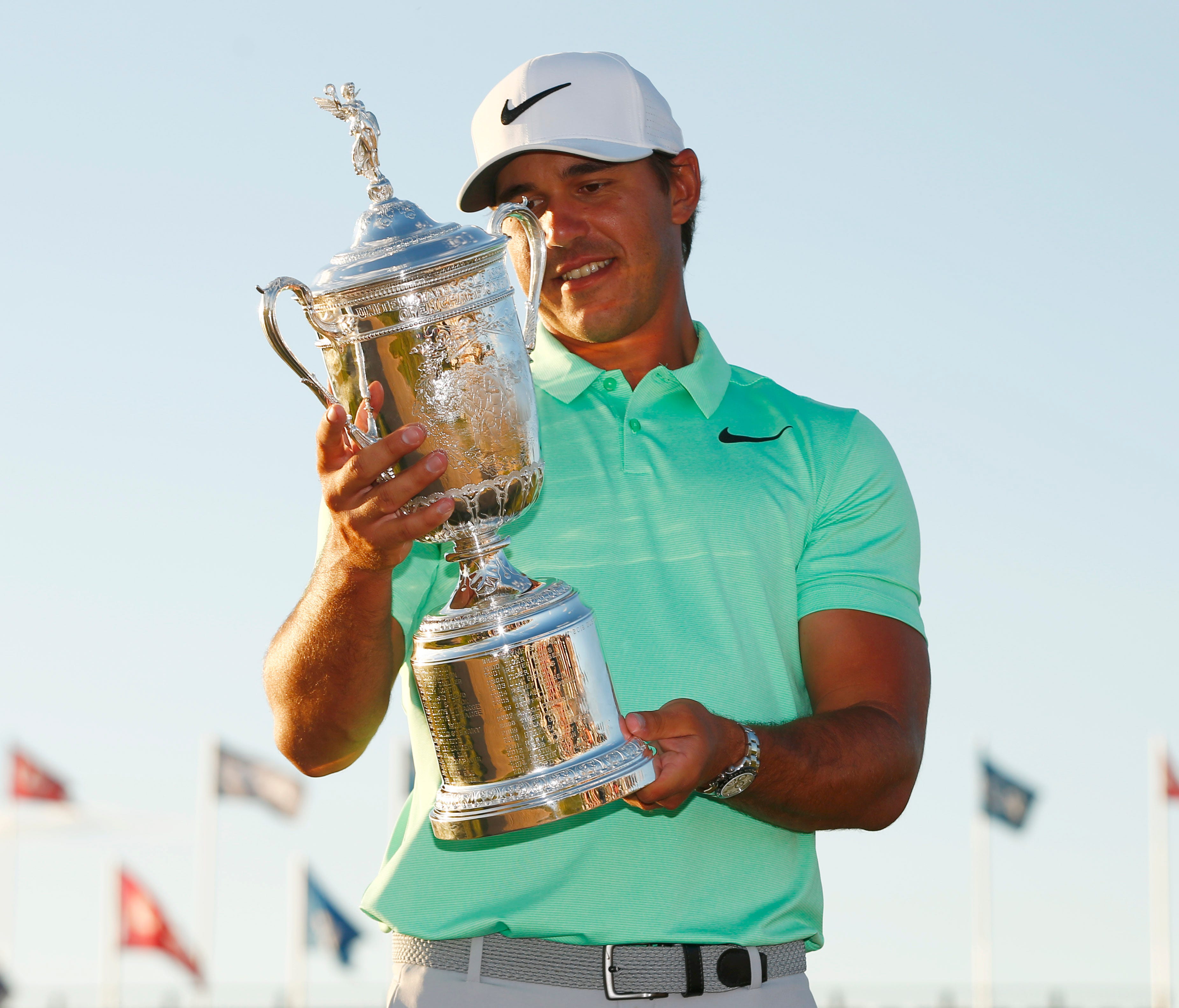 Brooks Koepka poses with the trophy after winning the U.S. Open at Erin Hills.