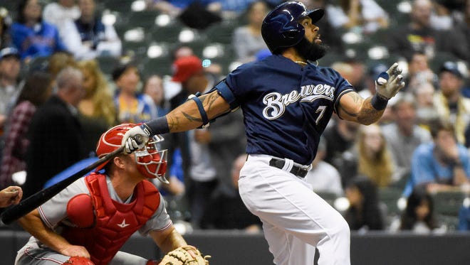 Brewers first baseman Eric Thames hits a two-run homer against the Reds at Miller Park.