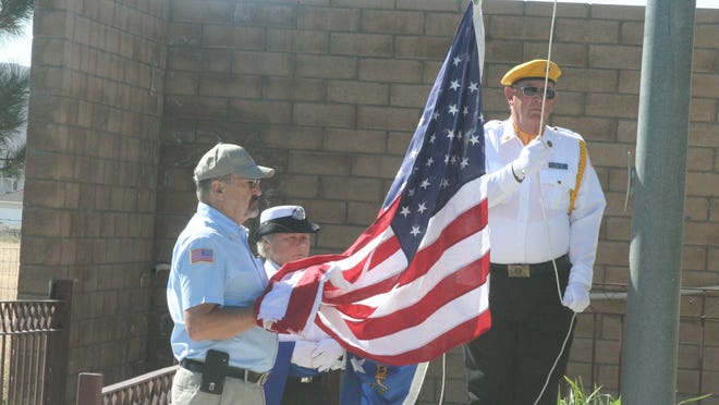 
Dave Cobb of the Lyon County Sheriff’s Office Volunteers in Policing, Mary Segewick of the Northern Nevada Veterans Coalition and Jerry Finley American Legion Post #37 raise teh U.S. flag during the Fernley Sept. 11 memorial cremony at the Out-of-Town Park.
