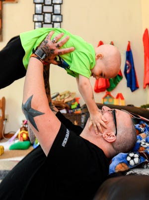 Kaleb Becker, 3, plays with his dad, Todd, in their Eaton Rapids home Friday, Sept. 30, 2016. Kaleb Becker was diagnosed with Acute Leukemia in August, the day of his father's 43rd birthday. The community is planning a fundraiser for the family. 
