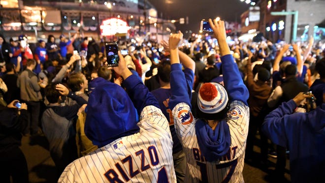 Nov 2, 2016; Chicago, IL, USA;  Chicago Cubs fans celebrate after game seven of the 2016 World Series against the Cleveland Indians outside of Wrigley Field. Cubs won 8-7.