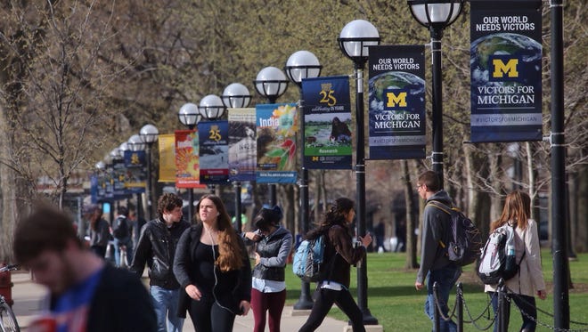Students walk along South State Street through the Ann Arbor campus of the University of Michigan in this 2014 file photo.