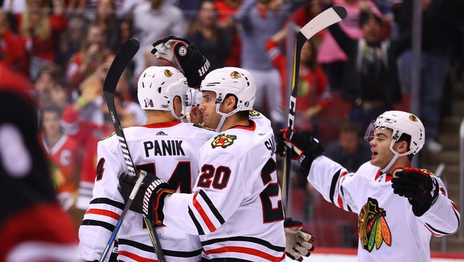 Oct 21, 2017; Glendale, AZ, USA; Chicago Blackhawks right wing Richard Panik (14) is congratulated by teammates after scoring a power play goal in the first period against the Arizona Coyotes at Gila River Arena. Mandatory Credit: Mark J. Rebilas-USA TODAY Sports