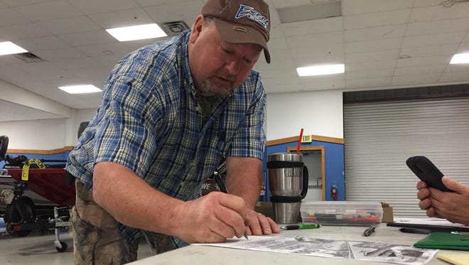 Ben Clemons registers for The Times All-City Bass Tournament at Bayou Outdoor Supercenter.