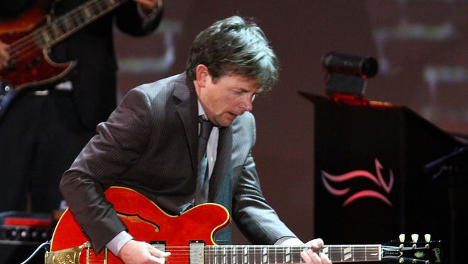 Michael J. Fox performs onstage at the 2011 A Funny Thing Happened On The Way To Cure Parkinson's event at The Waldorf-Astoria on November 12, 2011 in New York City.