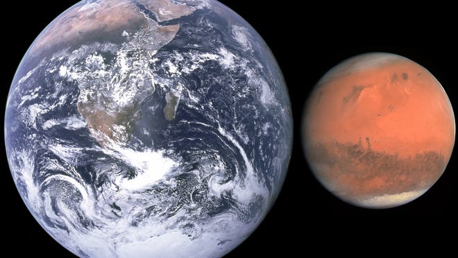 Earth and Mars are shown next to each other to compare their size. Thankfully Mars never comes this close!