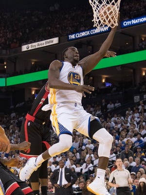 Golden State Warriors forward Draymond Green (23) scores against the Toronto Raptors Wednesday.