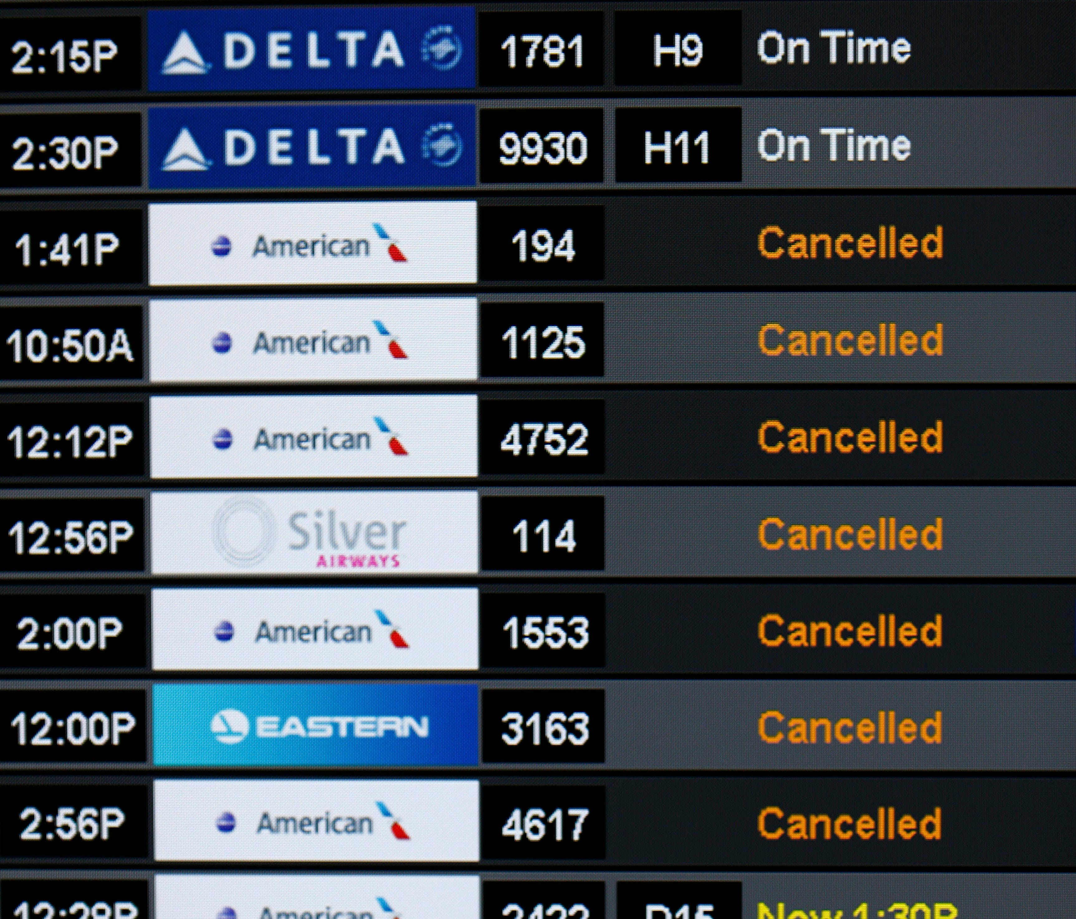 A monitor listing mostly canceled flights is seen at Miami International Airport on Friday, Sept. 8, 2017.