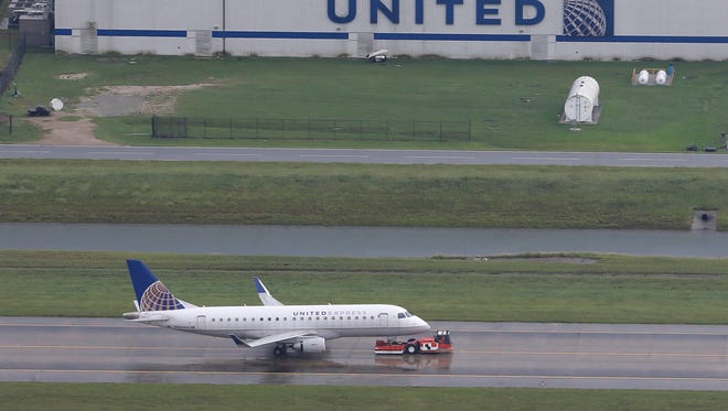 A United Airlines plane is towed at Houston's Bush Intercontinental Airport on Tuesday, Aug. 29, 2017. The airport was closed to commercial service at the time because of Harvey.
