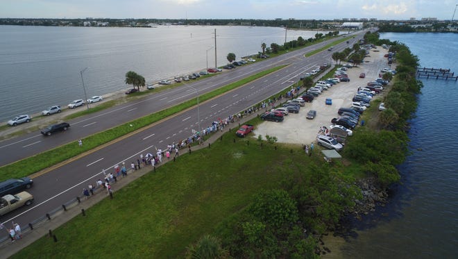 Hundreds of people lined the Eau Gallie Causeway during the June 30 Families Belong Together march, protesting the Trump administration's zero tolerance policy on illegal immigration.