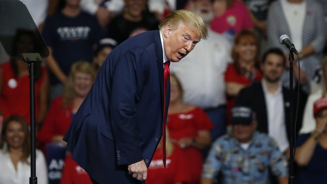 President Donald Trump at Saturday's campaign rally in Tulsa, Okla., walking across the stage as he talks about a recent appearance at West Point.