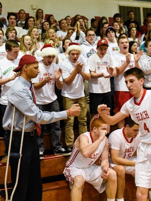 Assistant basketball coach Jeff Bryant is pictured at the game where Point Pleasant Beach boys hosted Mater Dei in basketball on Friday, December 19, 2014. Bryant, who was the center on last year's PPB championship team is now battling bone cancer but still helps out the team. Here he bangs fists with players during the introductions. /Russ DeSantis/Special to the Asbury Park Press / SLUG-ASB 1225 Edelson column