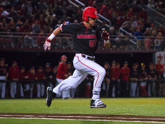 UL's Marco Ramos (22) runs to first base as the Ragin'