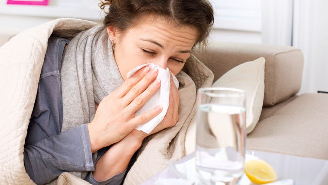Sneezing woman sick with the flu or cold.