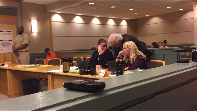 Vineland resident Jules R. Black (standing, left) stated Monday in Cumberland County Superior Court that he is choosing to stand trial on a murder charge rather than plead guilty in exchange for a 30-year prison sentence. His attorney, John Morris (standing, right), confers with county Assistant Prosecutors Lesley Snock (left) and Cathryn Wilson (right).